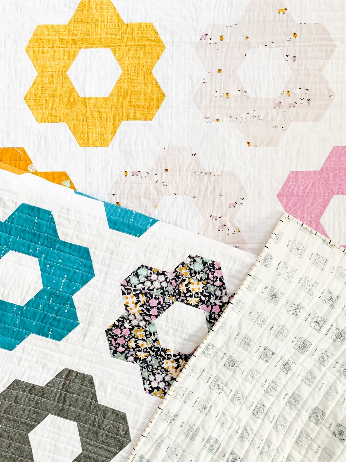 Colorful quilt with geometric patterns and a floral center