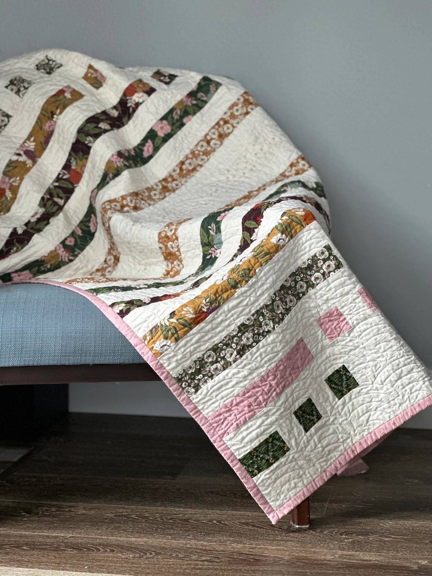picture of strip quilt thrown over a chair