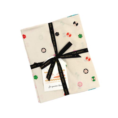 Two fabric fat quarter bundles with colorful patterns tied with a black ribbon on a white background.