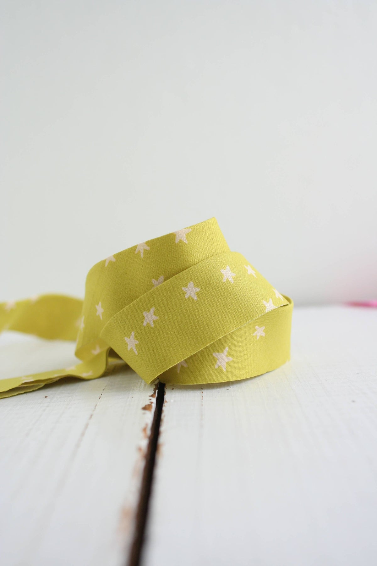 Yellow quilt binding with white star pattern on a white background