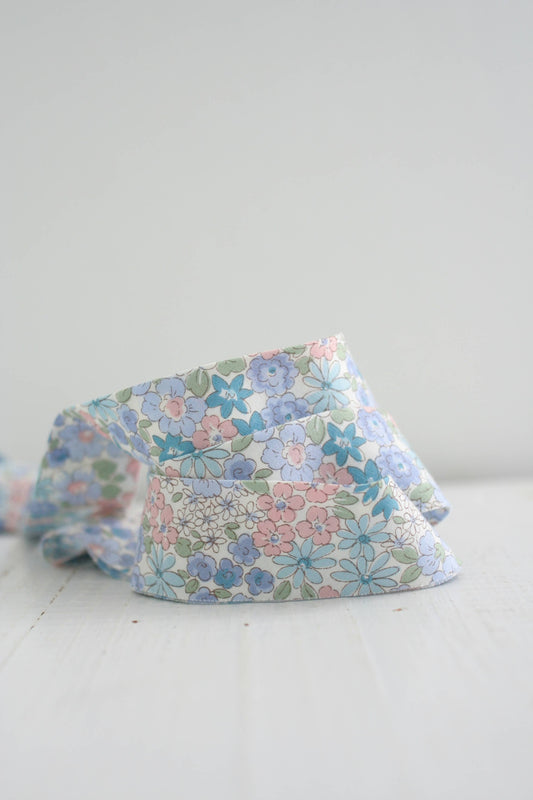 Floral-patterned fabric bias quilt binding on a white surface