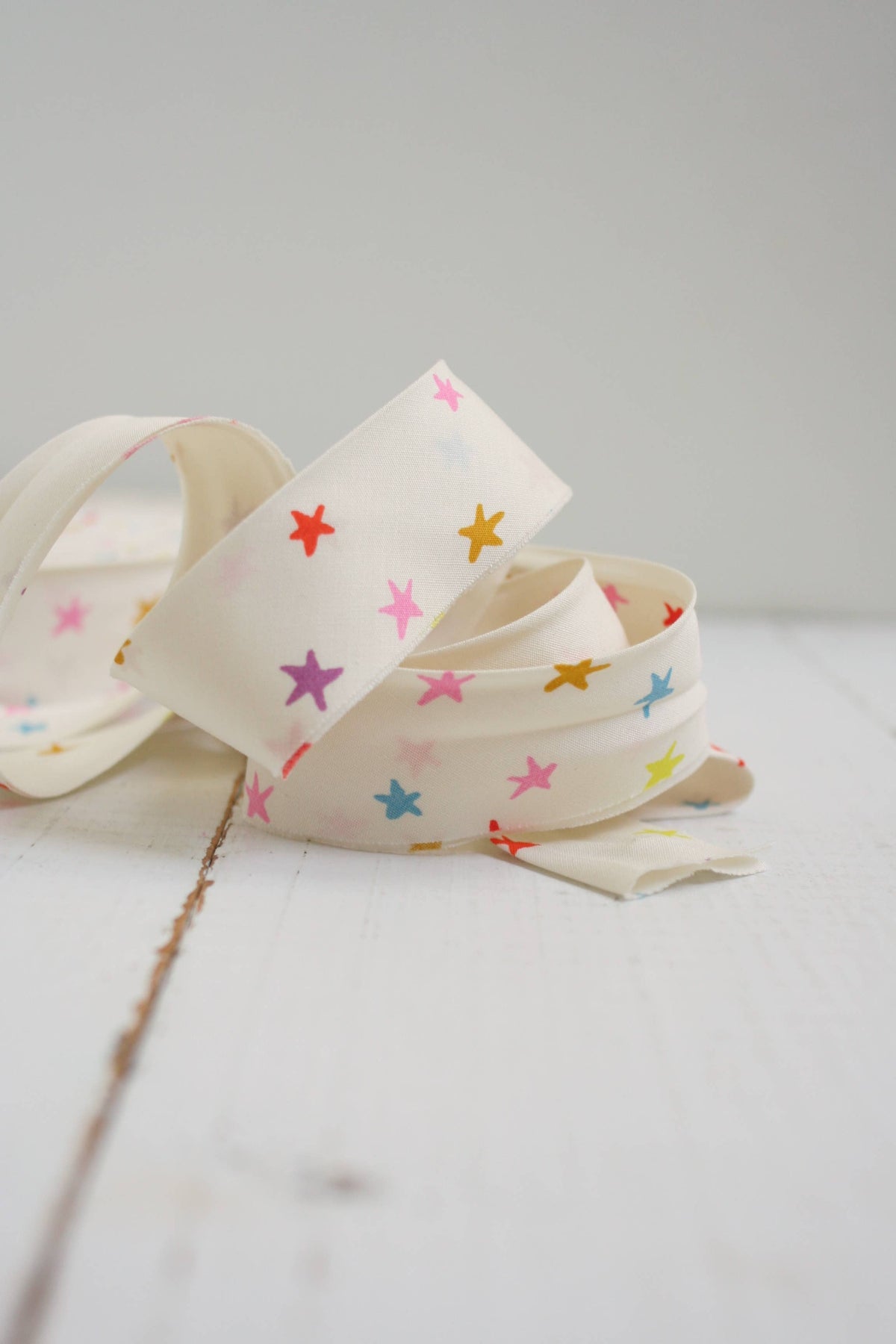 Bias Quilt Binding with colorful star patterns on a light gray background