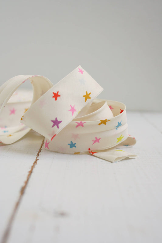 Bias Quilt Binding with colorful star patterns on a light gray background