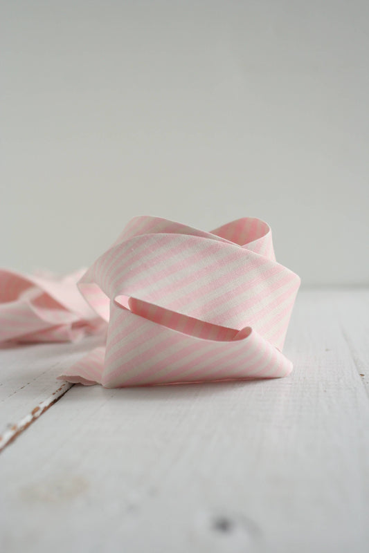 Pink striped fabric on a white surface
