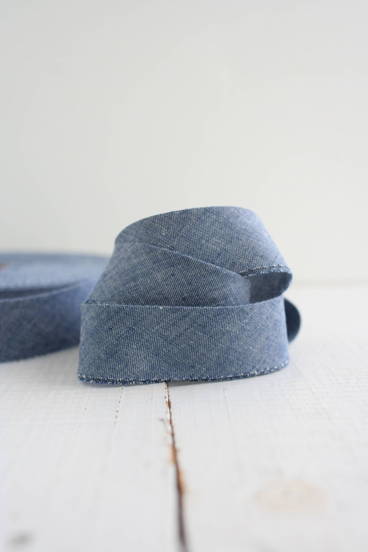 Blue denim quilt bias binding on a white surface