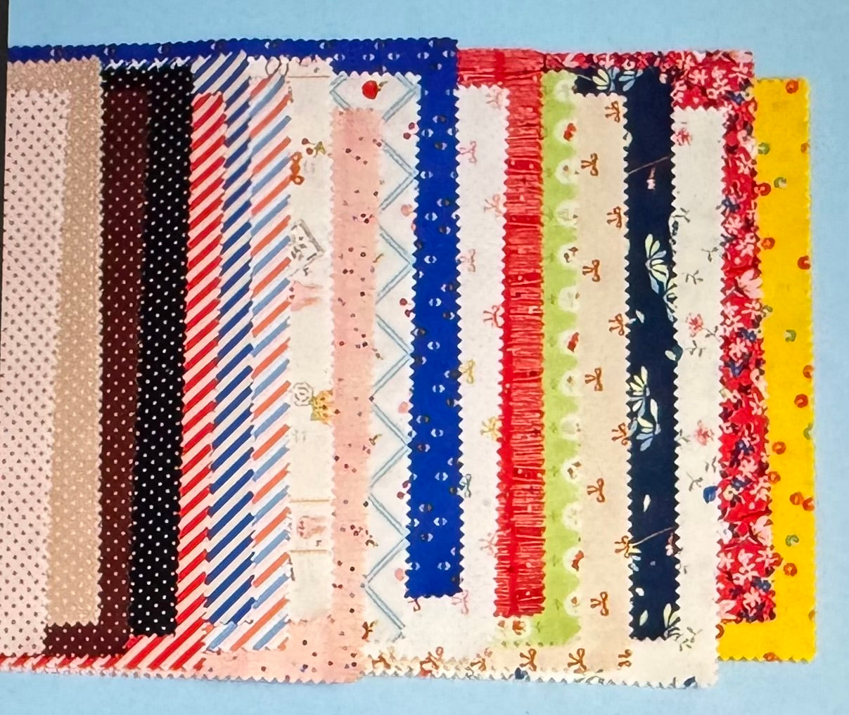 Collection of fabric swatches with various patterns and colors on a blue background