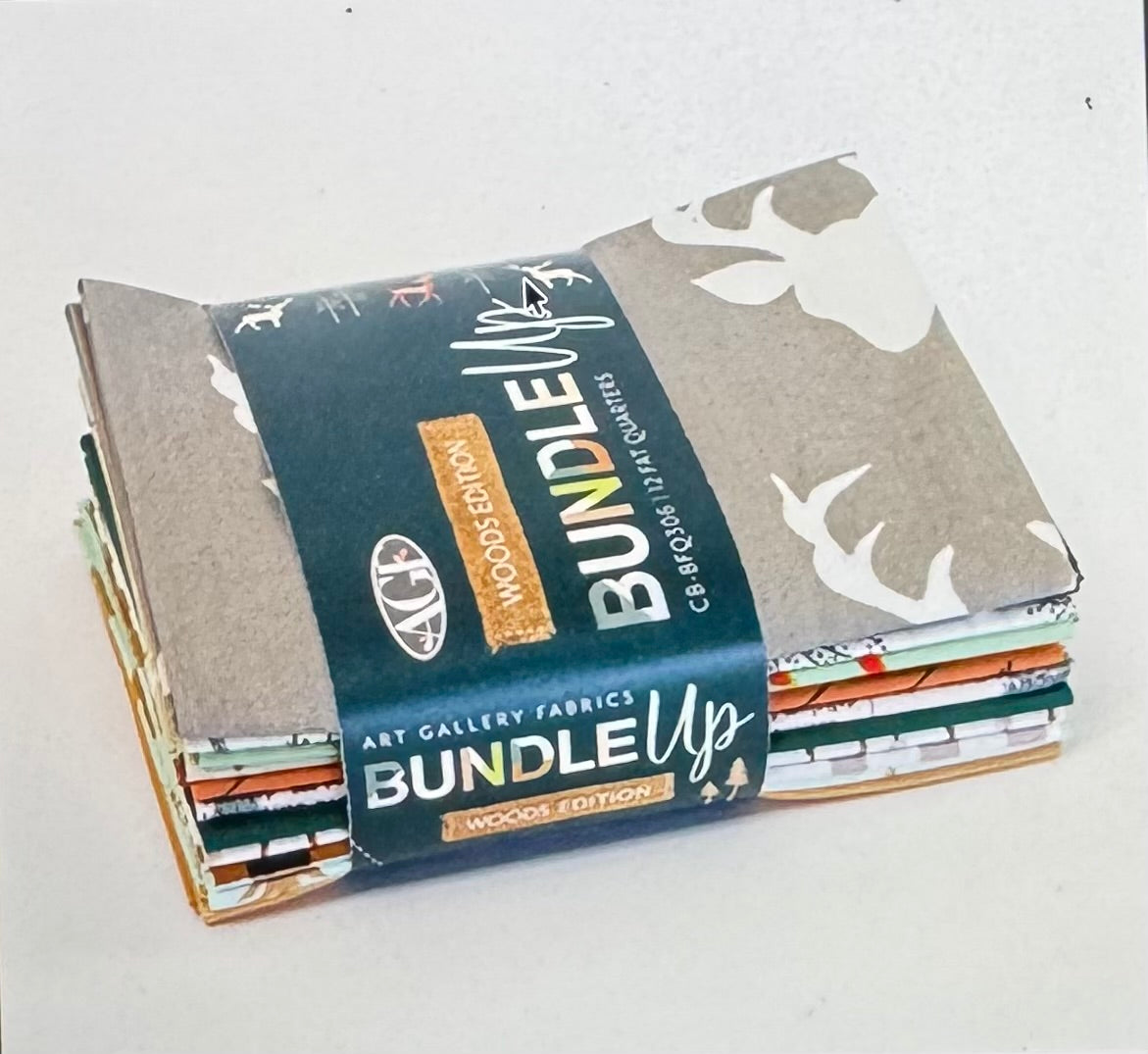 Stack of fabric bundles with a visible label on a white background
