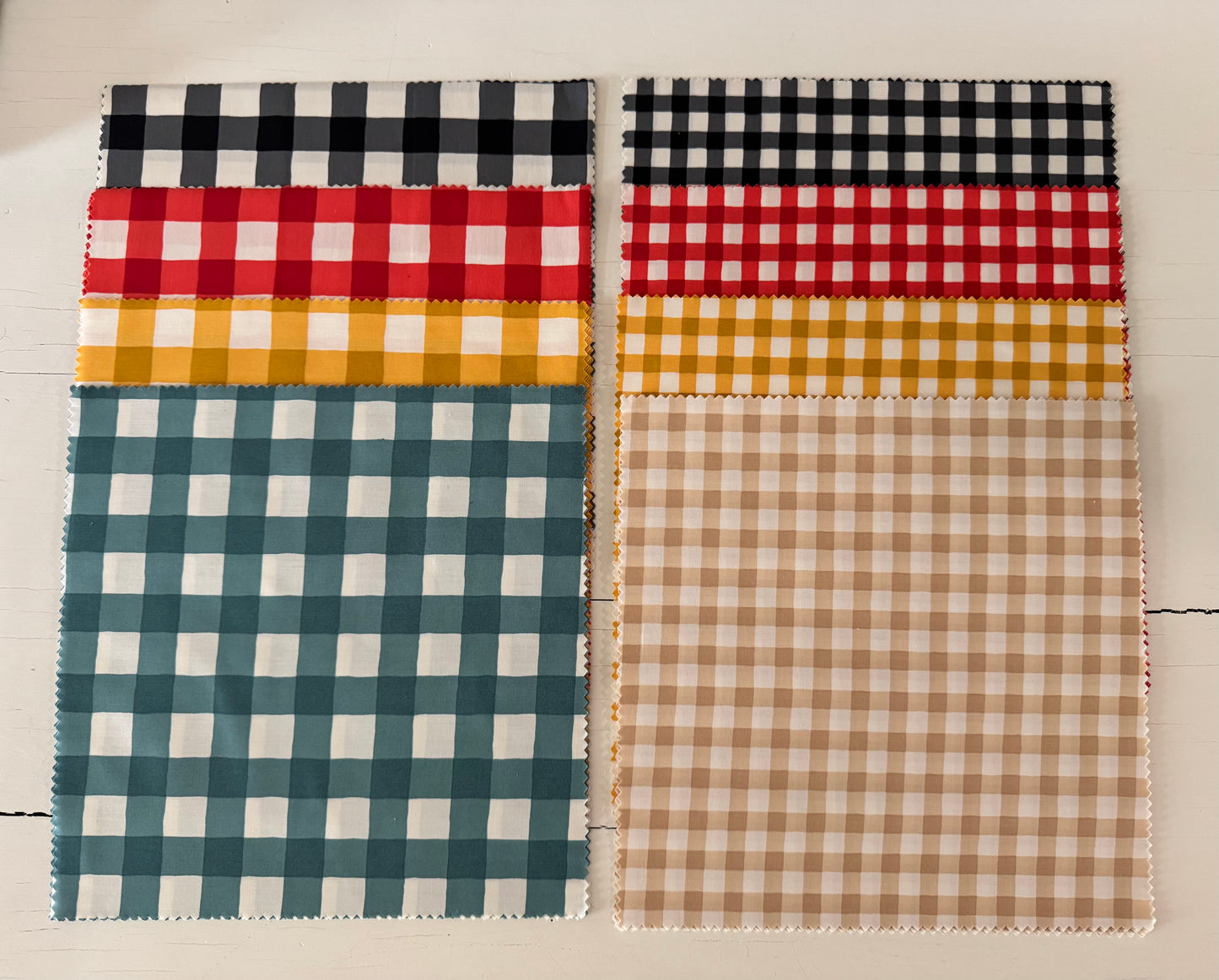 Four different checkered fabric swatches on a light background
