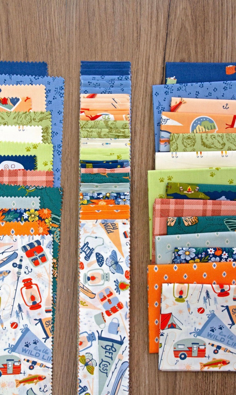 Collection of colorful fabric swatches arranged vertically on a wooden surface.