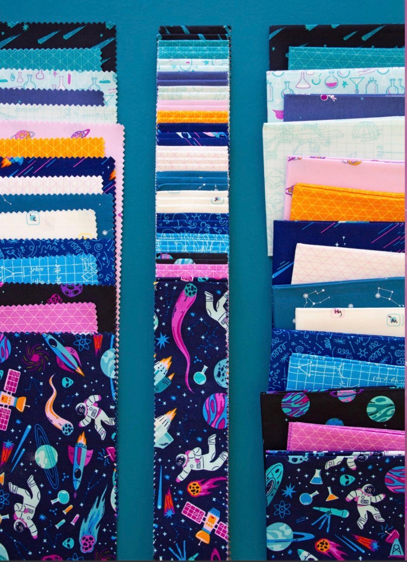 Collection of colorful fabric strips with space-themed designs on a blue background