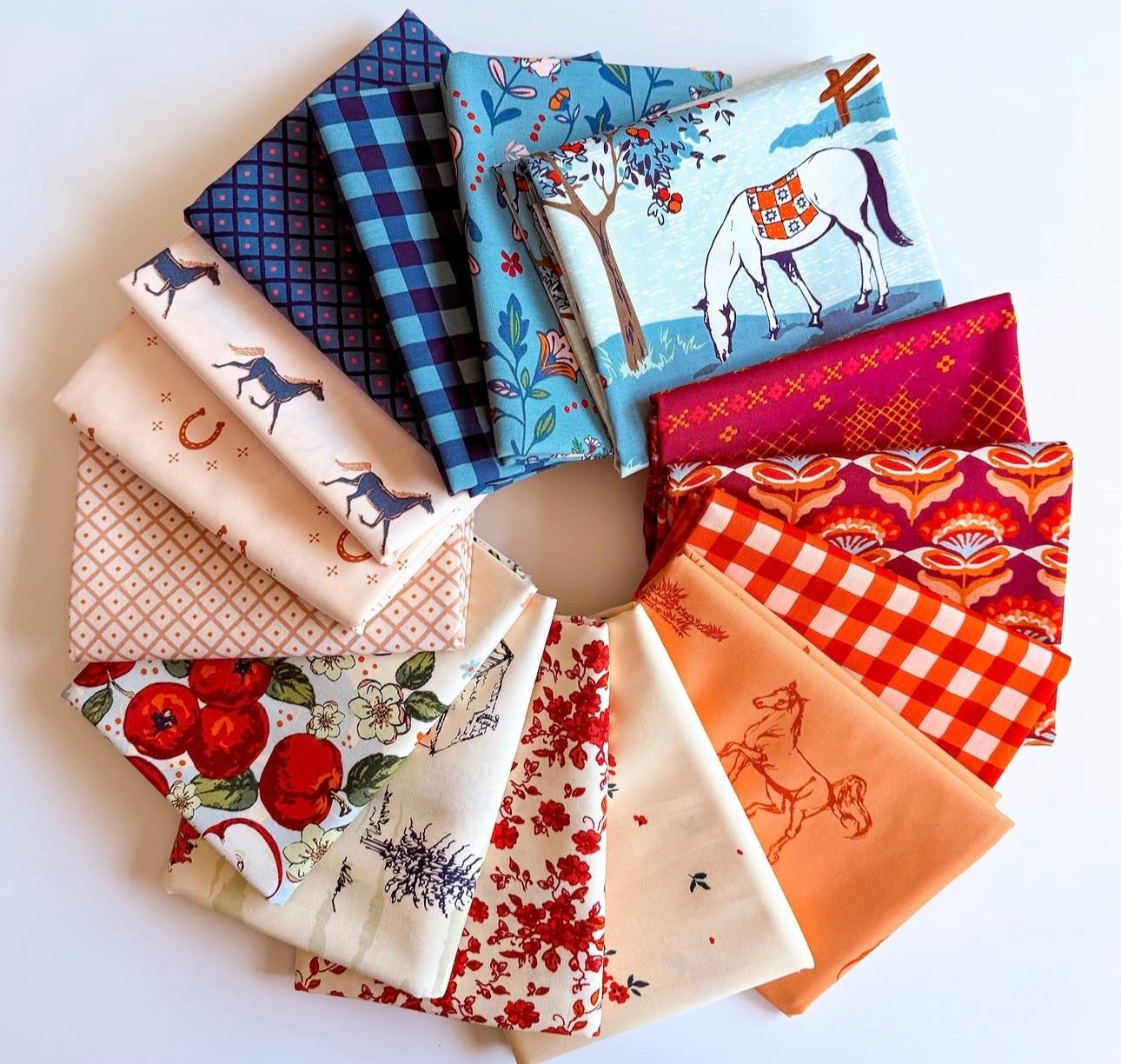 Fat Quarters o a table. Horse and orchard theme