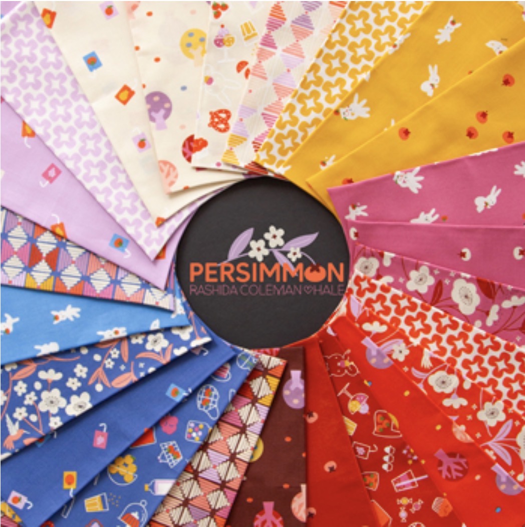 Fabrics fanned out on a black background. the word Persimmon printed in middle