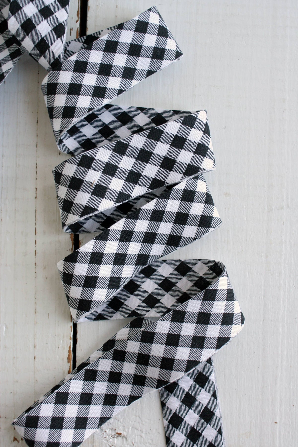 Black and white checkered ribbon on a wooden background