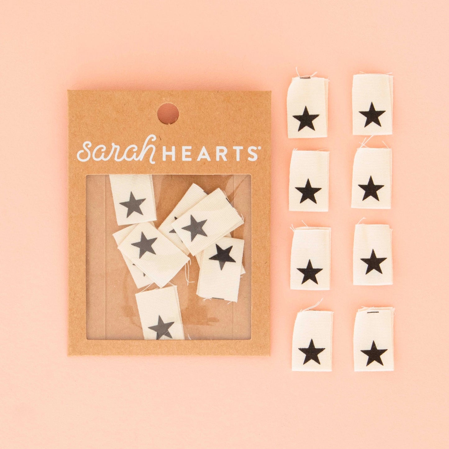 Packaged star-shaped tags with 'Sarah Hearts' branding on a pink background