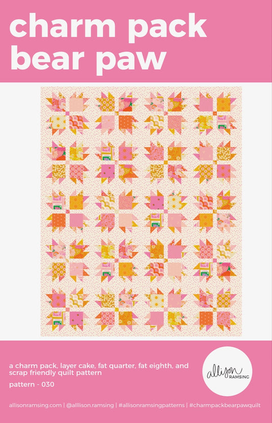 Quilt pattern cover with pink and orange bear paw design on a light background