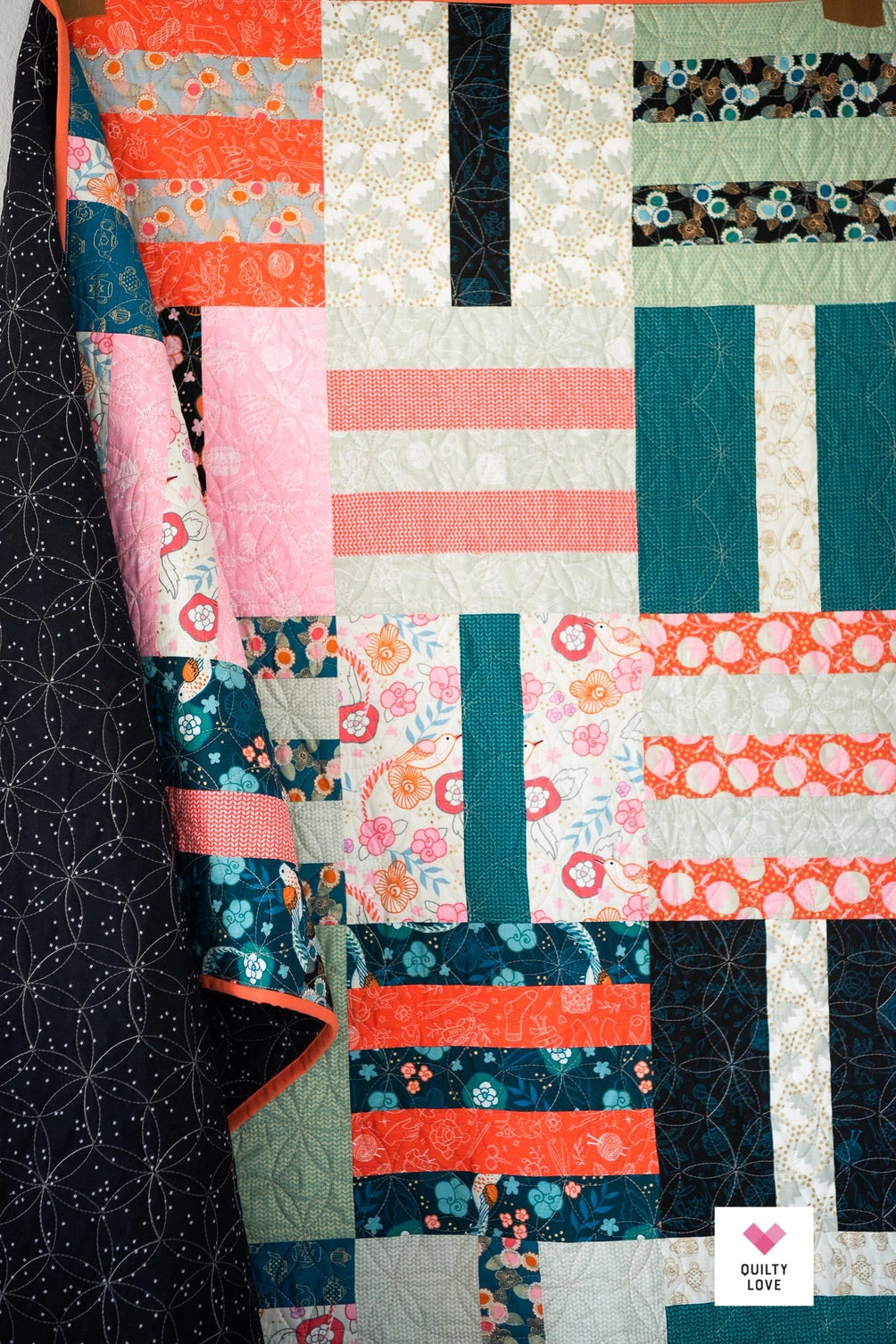 Colorful quilt with geometric patterns on a dark background