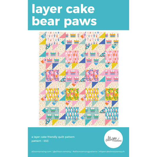 Quilt pattern cover with colorful geometric design and 'layer cake bear paws' text on a white background.