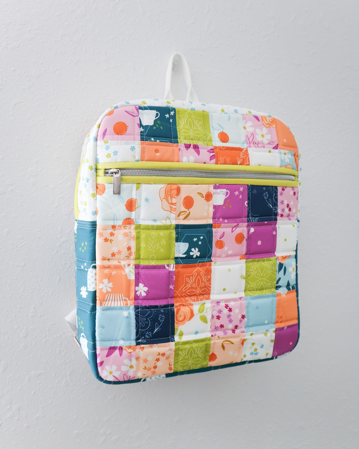 Colorful patchwork backpack on a gray background