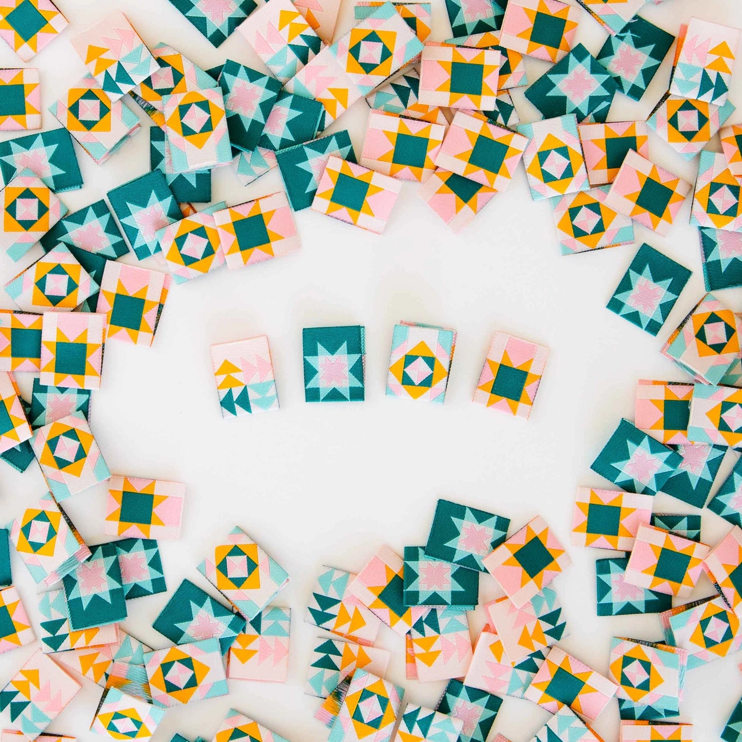 Colorful  quilt design tags arranged in a circular pattern on a white background