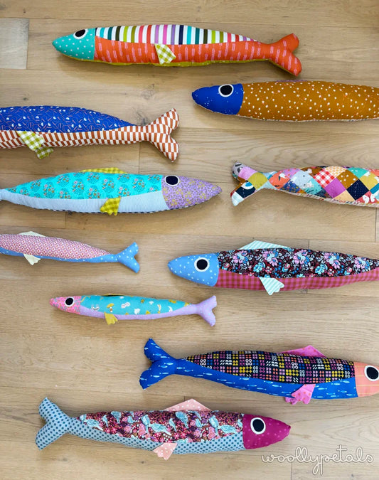 Colorful fish-shaped toys on a wooden surface