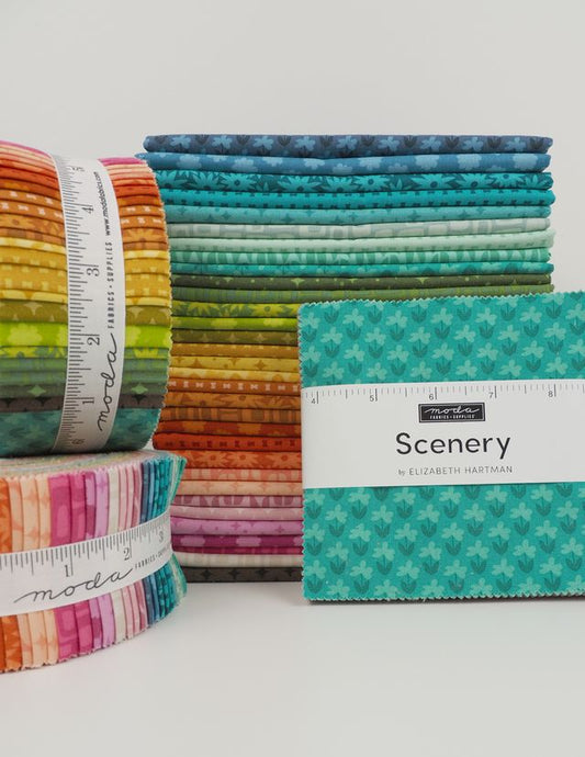 Stack of colorful fabric rolls with a labeled fabric square on a white background