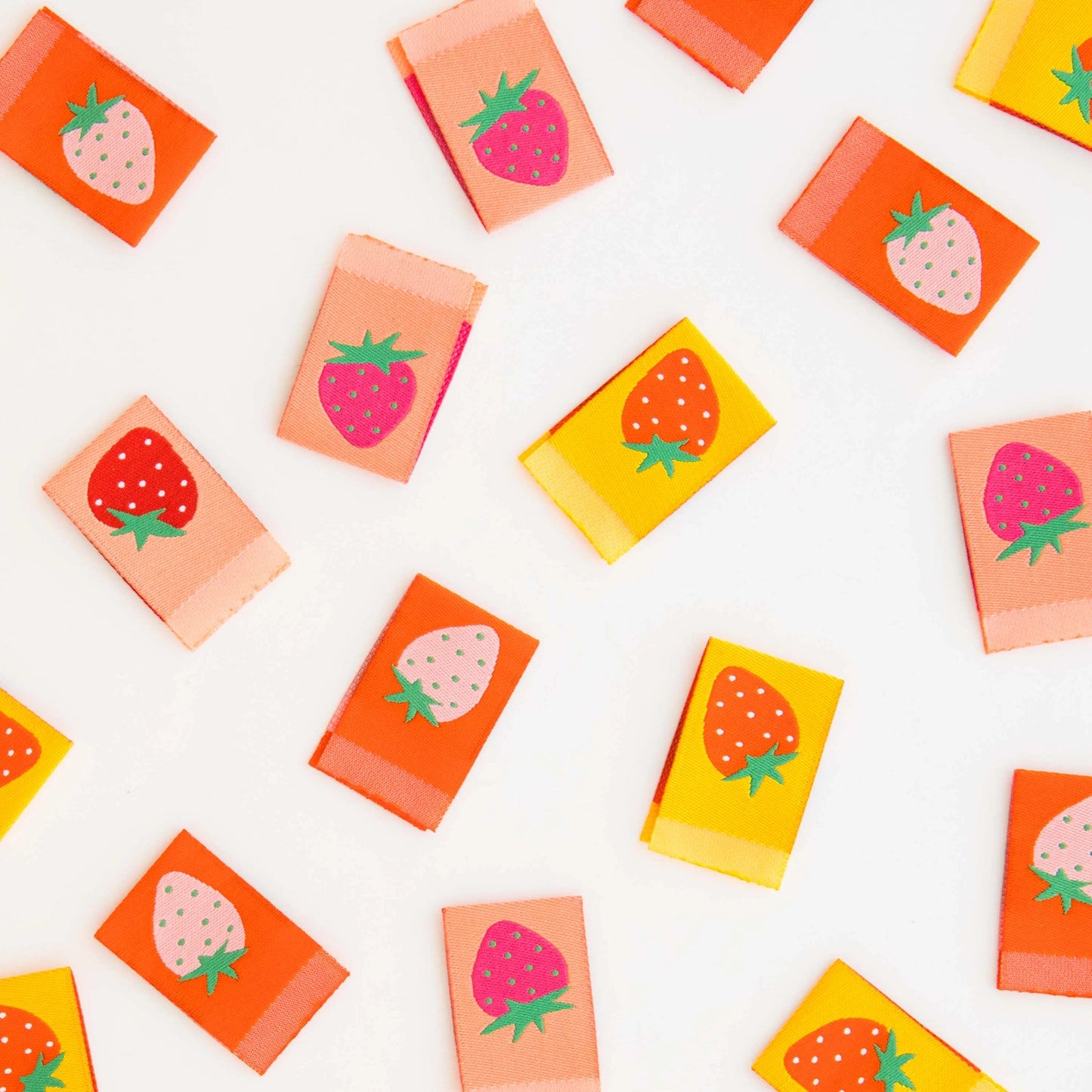 Colorful tags with strawberry design on a white background